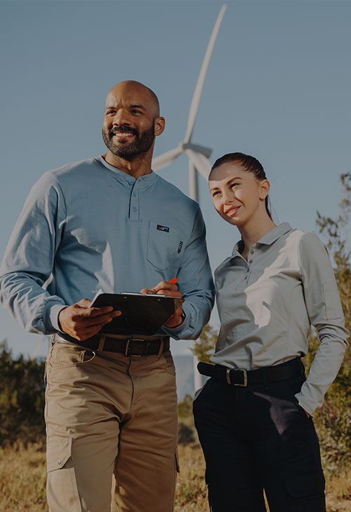 Two people in front of a windmill